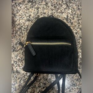 Black Mini Backpack With Adjustable straps. Lightly worn. Good Condition.